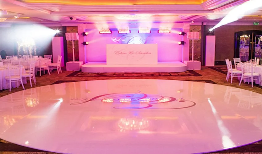 Warm-lit reception with a custom initial dance floor
