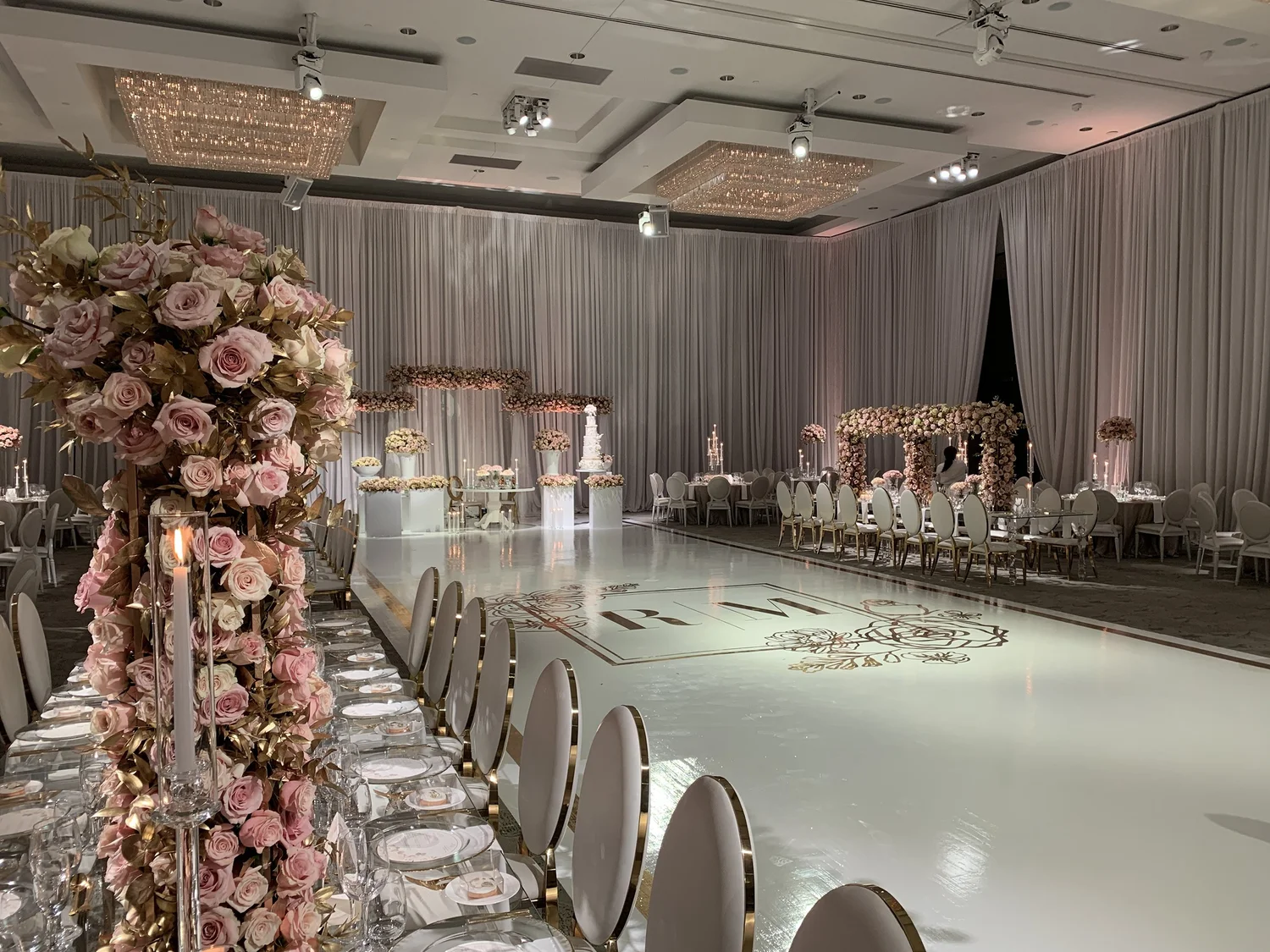 Full floral aisle leading to a white dance floor
