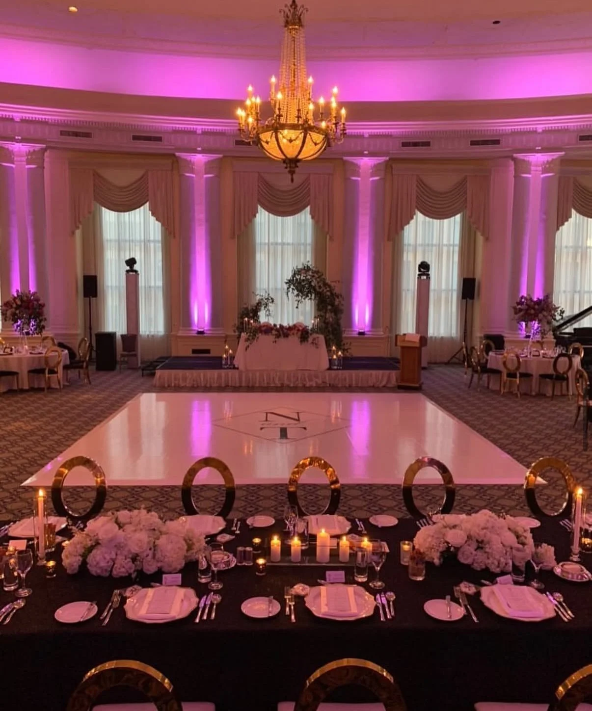 Pink-lit reception with a custom dance floor