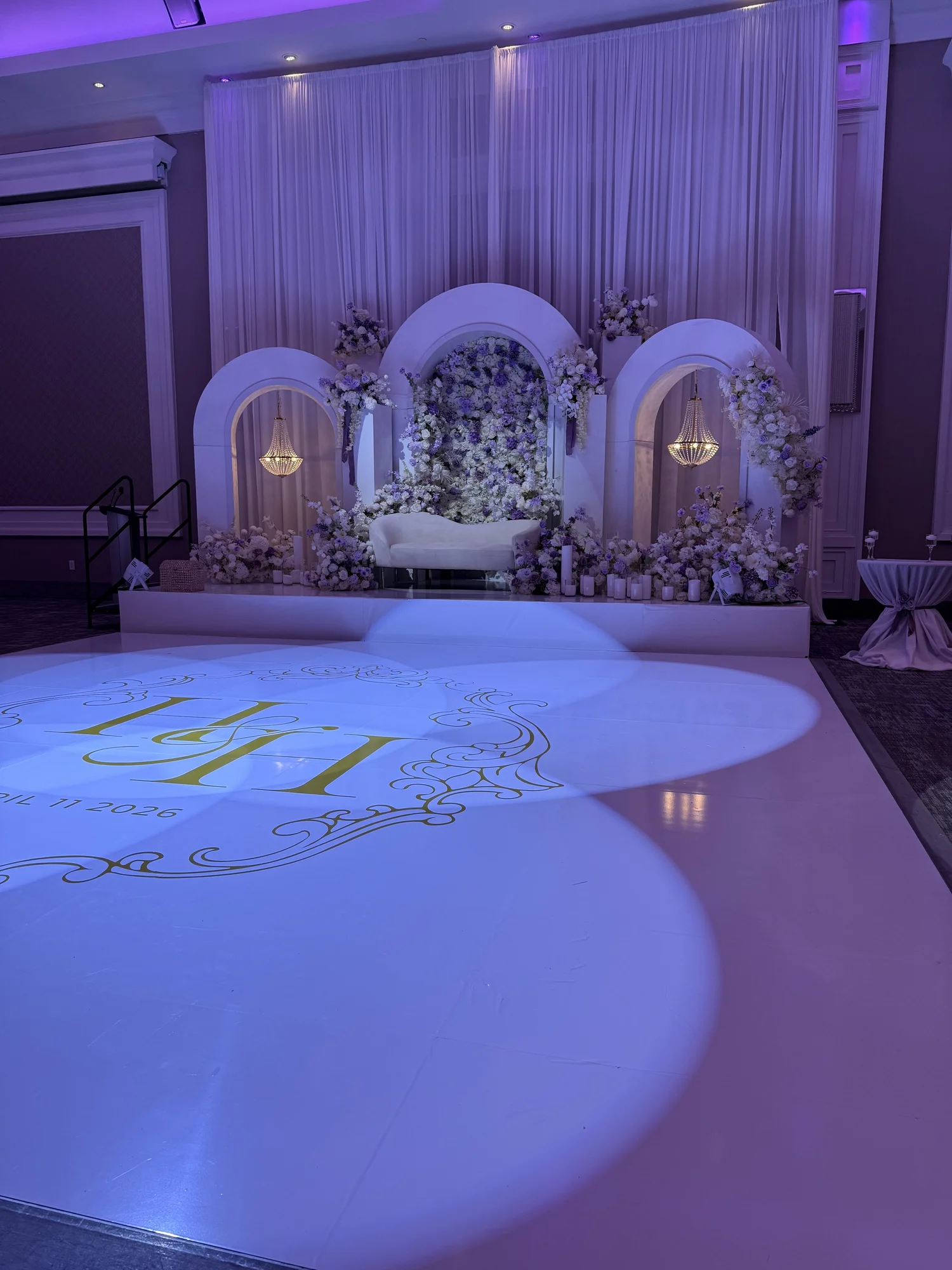 Purple-lit stage with a monogram dance floor
