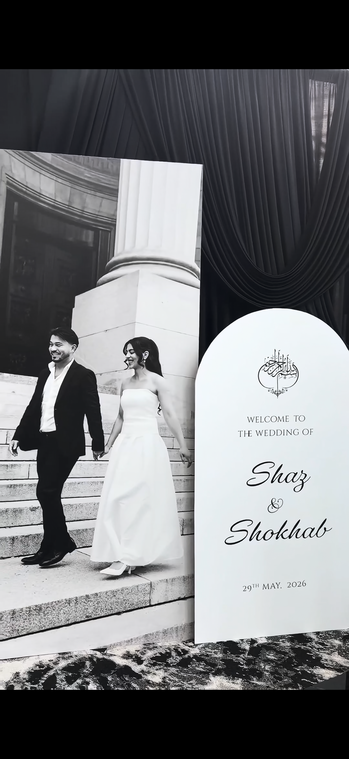 Couple beside their custom welcome sign